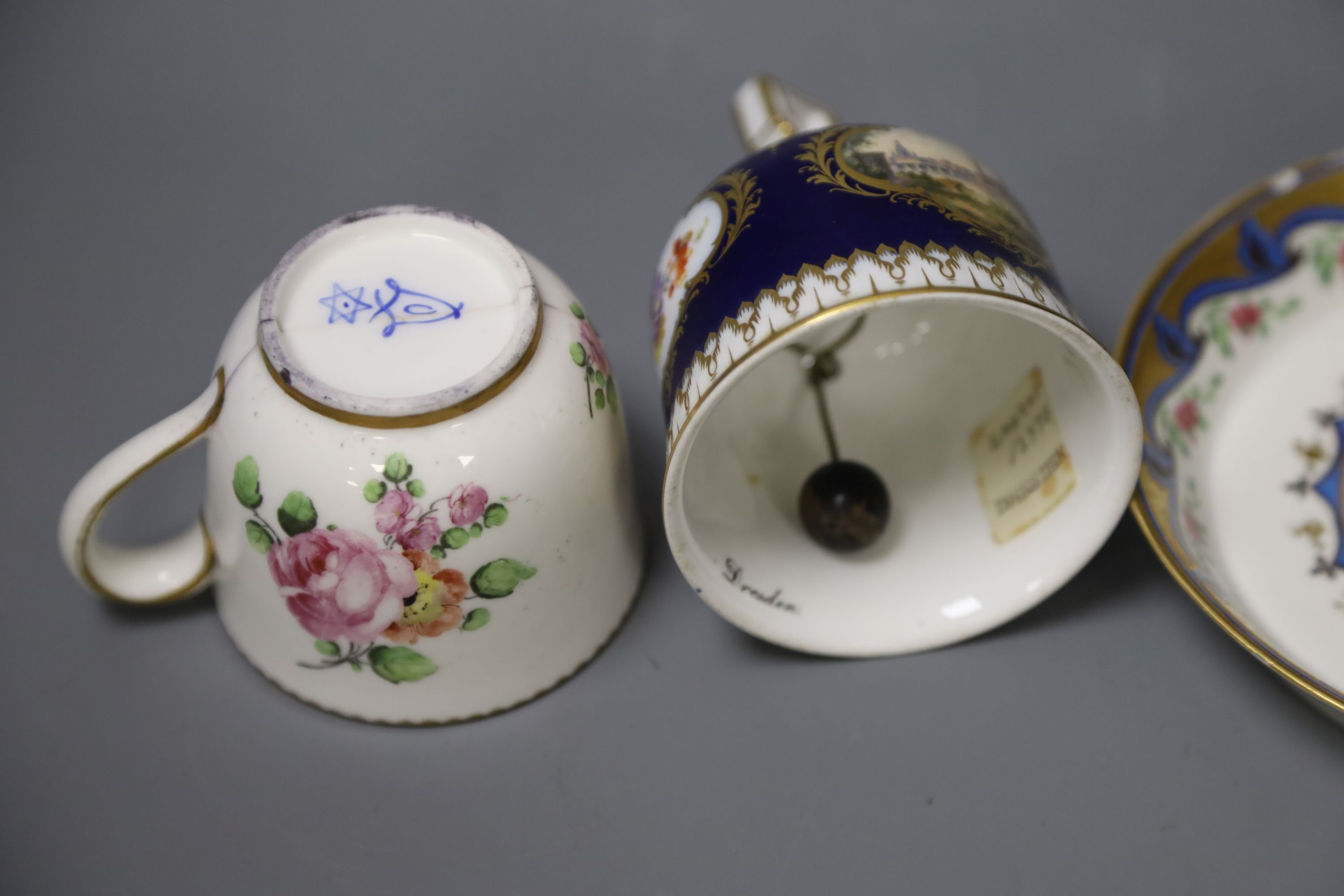 A Meissen hand-painted table bell, a Vienna saucer, diameter 13.5cm, and a Sevres cup